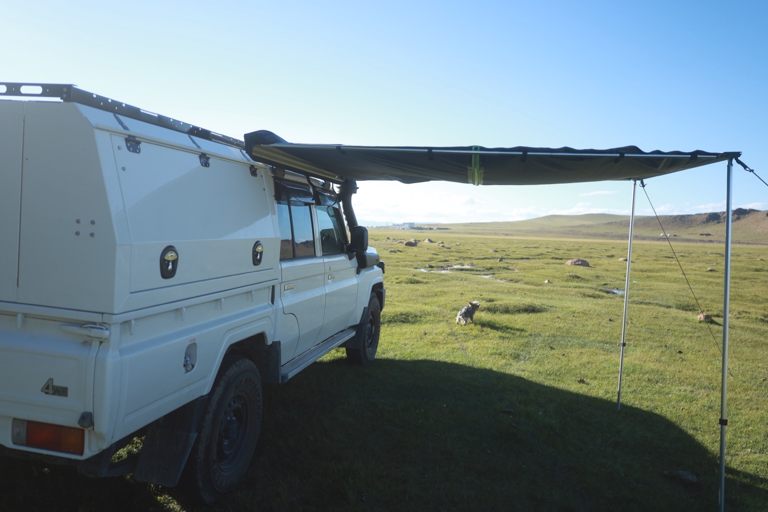 Land Cruiser 79 camping under its awning in the Mongolian landscape